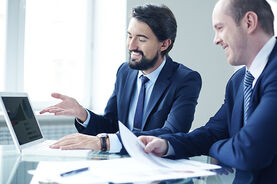 526034451-two-smiling-men-laptop-large