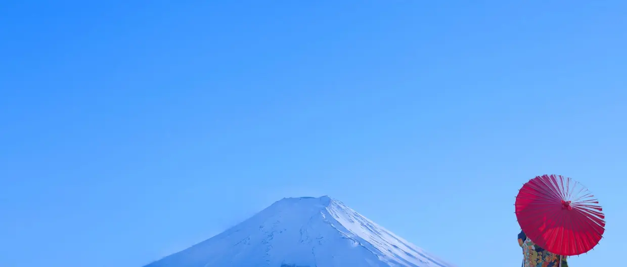 Person with umbrella with Mount Fuji in background