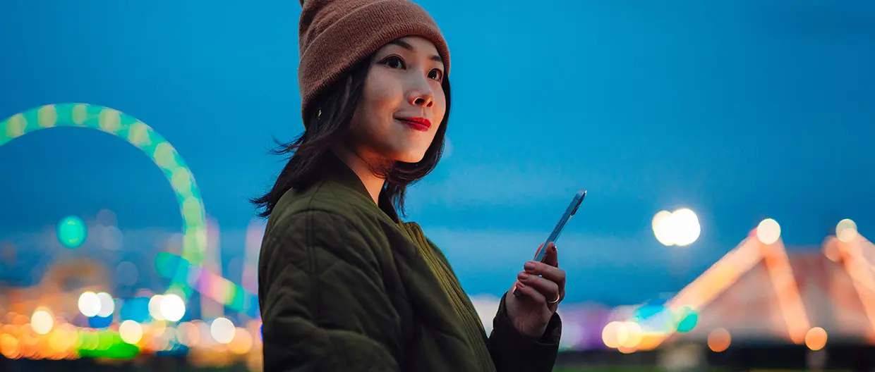 A young Asian woman holding a smartphone