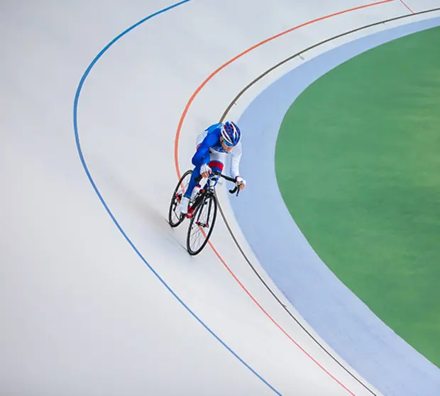 A cyclist on an indoor cycling track