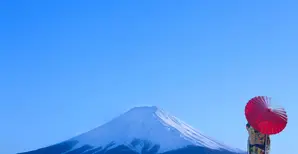 Person with umbrella with Mount Fuji in background