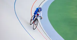 A cyclist on an indoor cycling track