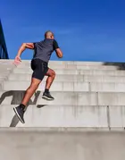 A runner scales up the stairs.