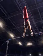 A male gymnast on a fixed bar