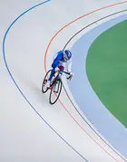 A cyclist on an indoor cycling track