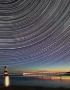 lighthouse at sea at night