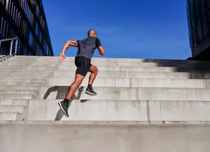 A runner scales up the stairs.
