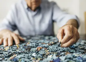 senior man doing a jigsaw