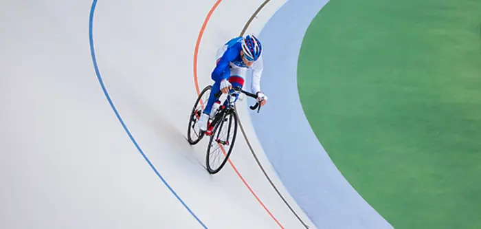 A cyclist on an indoor cycling track