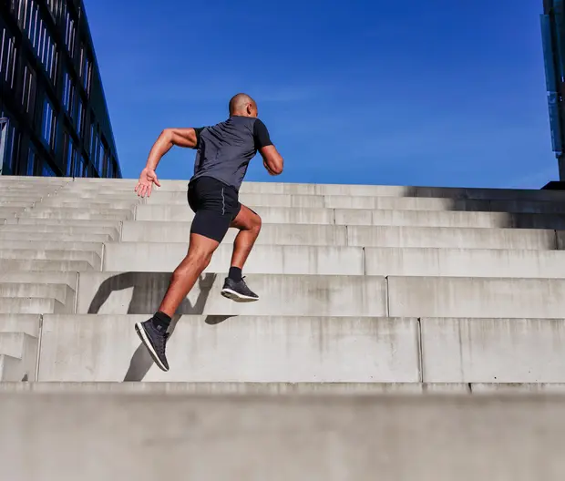 A runner scales up the stairs.