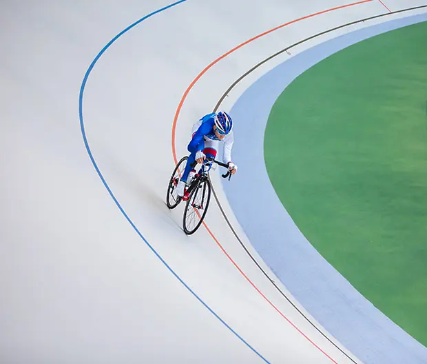 A cyclist on an indoor cycling track