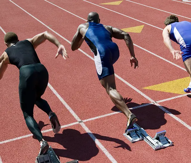 Male runners sprinting on a track