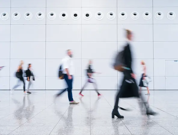 Blurred passers-by.