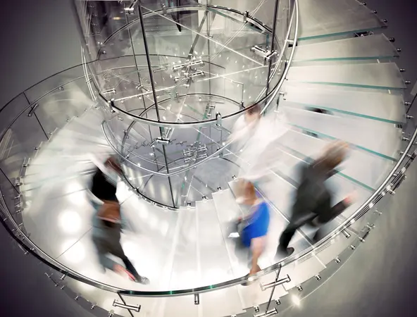 Blurred business people on a spiral staircase