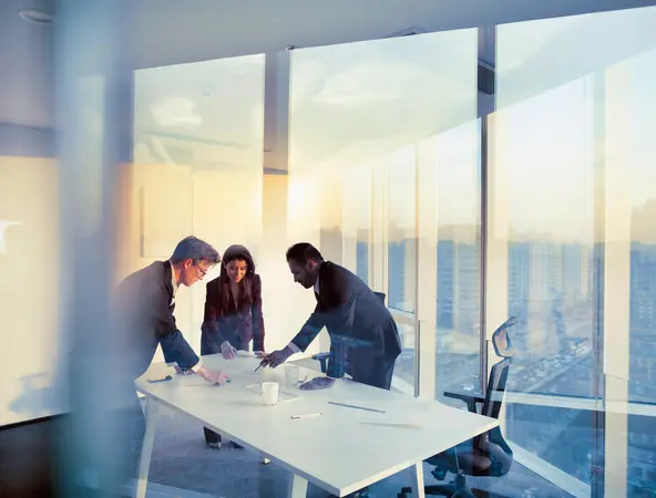 A group of business people grouped over a table