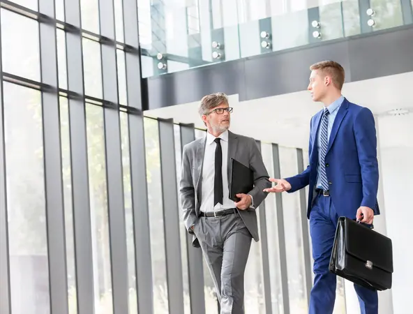 Businessmen discussing plans before meeting in office