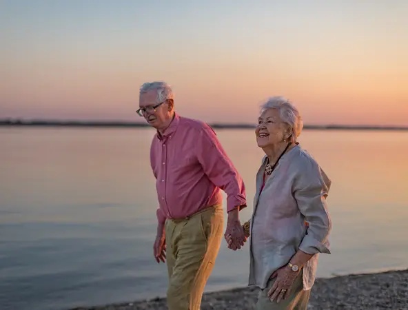 retired couple beach walking