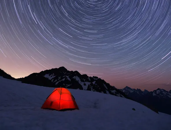 tent in lights camping in snowy mountain