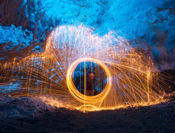 A long-exposure photograph capturing light trails from burning steel wool being spun
