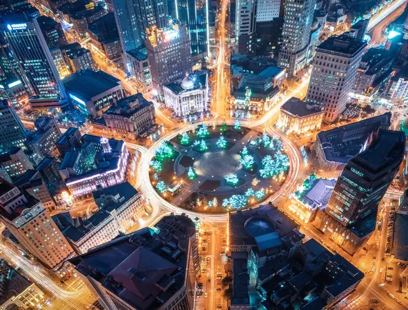 An artistic, abstract depiction of light trails, using long-exposure photography of a city roundabout