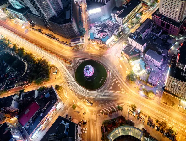 An artistic, abstract depiction of light trails, using long-exposure photography of a city roundabout