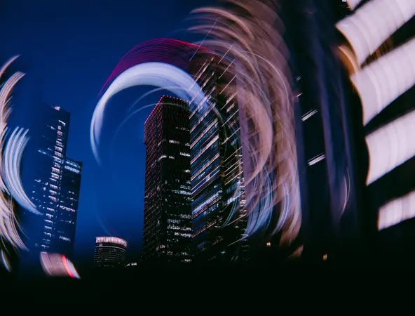A dynamic, long-exposure photograph of the Shanghai skyline, featuring the Oriental Pearl Tower and other skyscrapers, taken using a camera rotation technique.