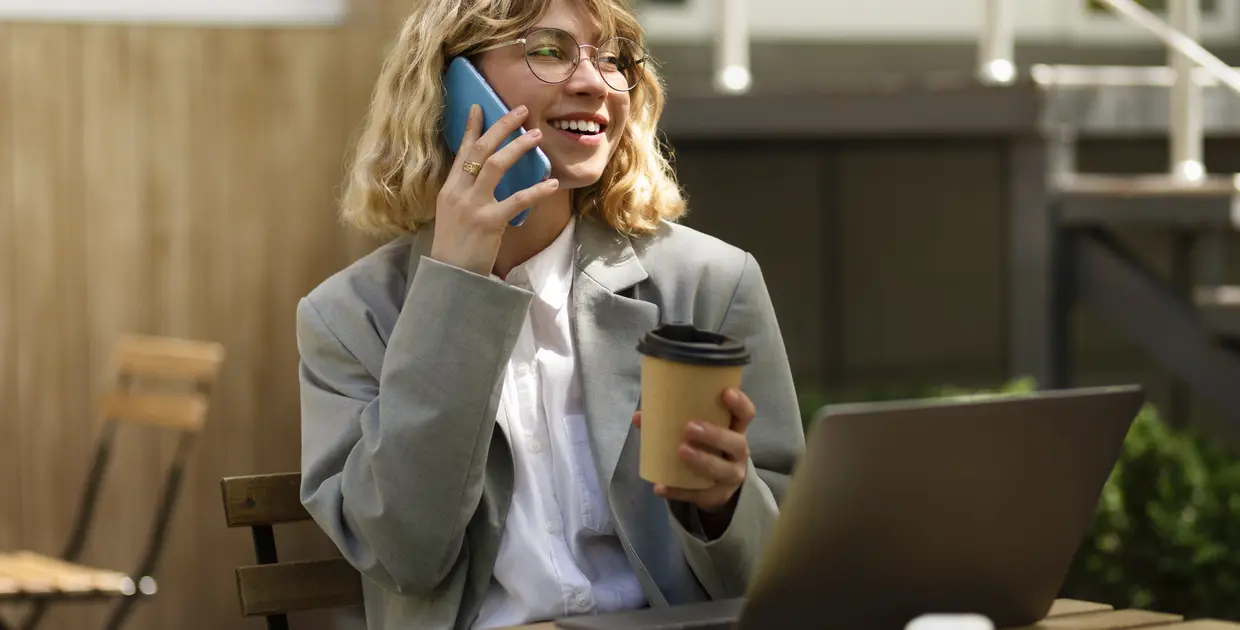 smiley-woman-talking-phone-medium-shot.jpg