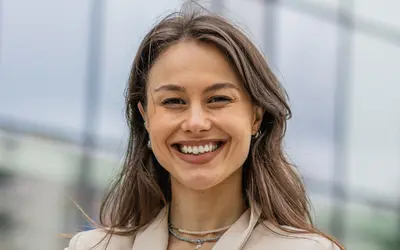 Une gestionnaire de portefeuille se tenant devant des bureaux modernes d'Amundi.