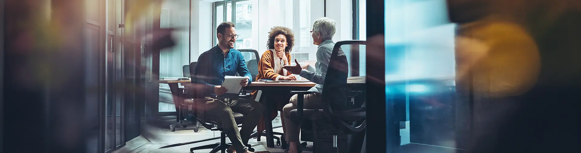 Trois experts en gestion d'actifs discutent dans les bureaux d'Amundi.