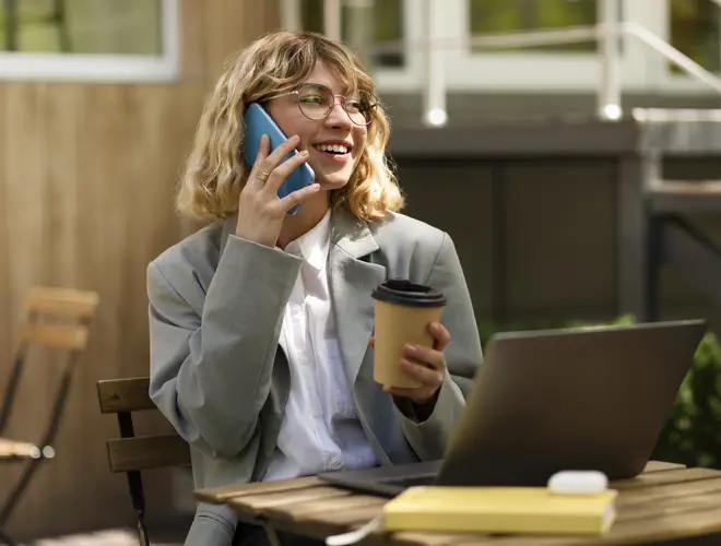 smiley-woman-talking-phone-medium-shot.jpg