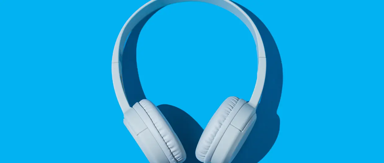 wireless white headphones on blue background