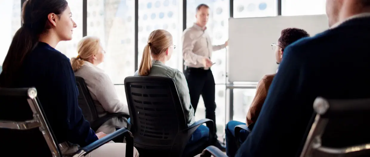 Group sitting in front of a whiteboard