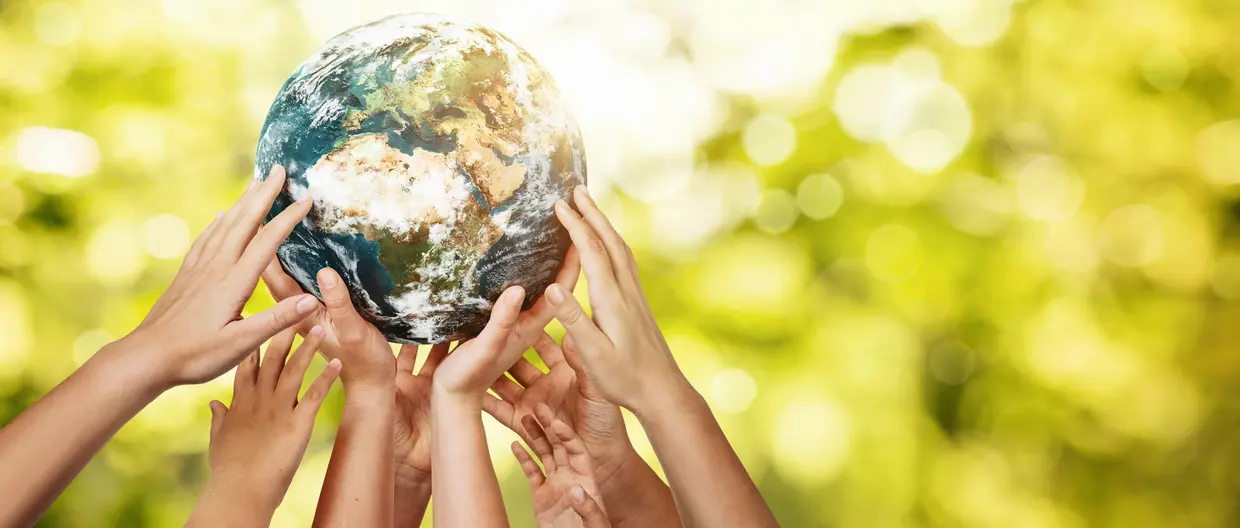 people's hands holding up the  globe