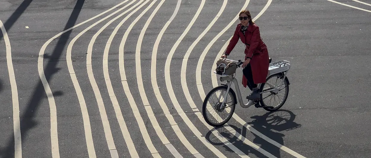 a woman riding a bike, choosing a track from many