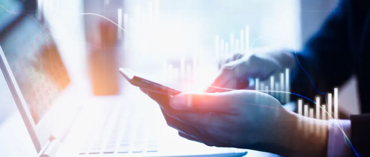 businessman touching a smartphone with stock graph on it