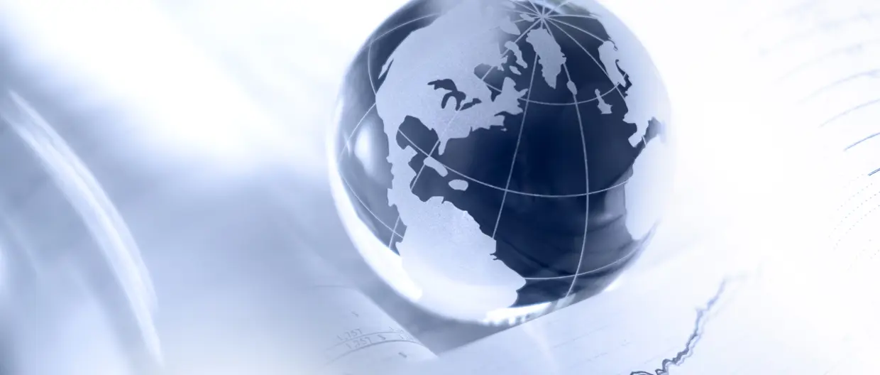 Glass globe and financial charts