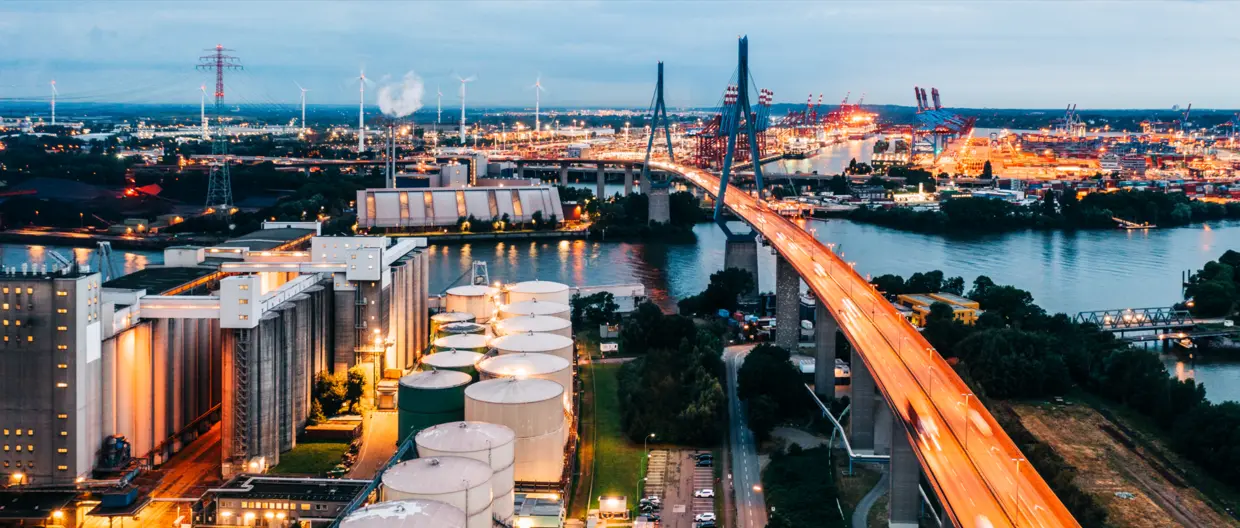 An illuminated power station, flyover and Hamburg docks