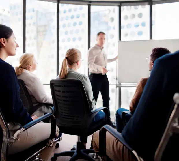 Group sitting in front of a whiteboard