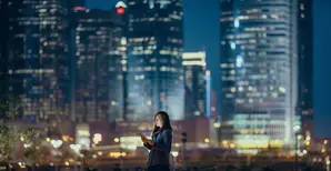 Woman in cityscape at night