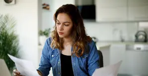 a girl reading documents at home