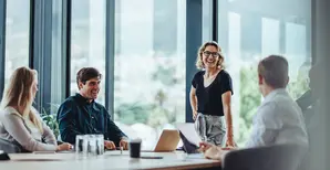Group of people sitting around a table in an office