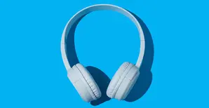 wireless white headphones on blue background