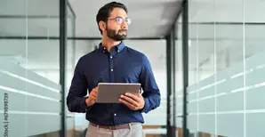 Young man with a tablet in the office corridor