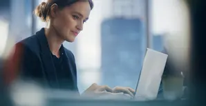 Woman working on a laptop in an office