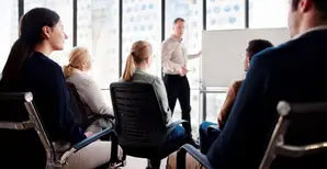 Group sitting in front of a whiteboard
