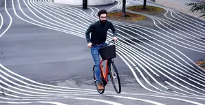 A man riding a bike in many tracks 