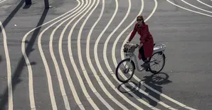 a woman riding a bike, choosing a track from many