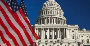 united_states_capitol_west_with_group_of_american_flags_in_washington_dc
