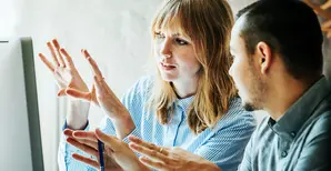 woman demonstrating something on the monitor