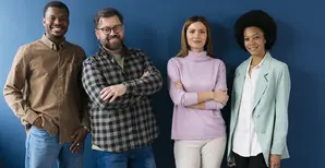 group of 4 people in front of a blue background